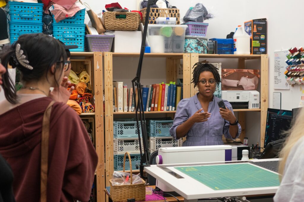 First-year MFA student Jasmine Best speaks to guests in her studio space in the Lamar Dodd School of Art during the Art Party Extravaganza on September 16, 2022.