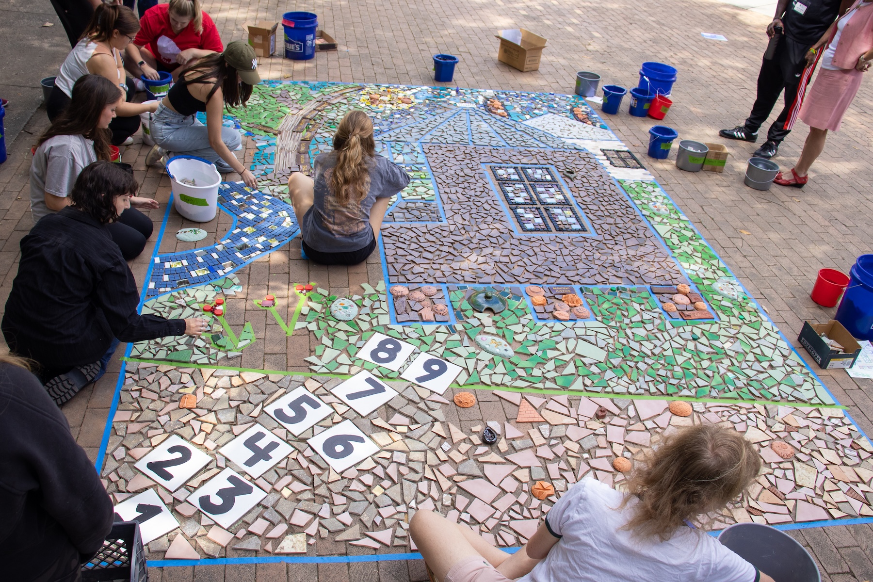 Students and participants assemble the Linnentown Living Mosaic at the University of Georgia Memorial Hall Plaza on October 3, 2022.