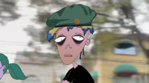 Still of digital animation. Center of frame shows character with green beret, blue-tipped blonde hair, dark undereye circles. Background shows blurred streetscape.